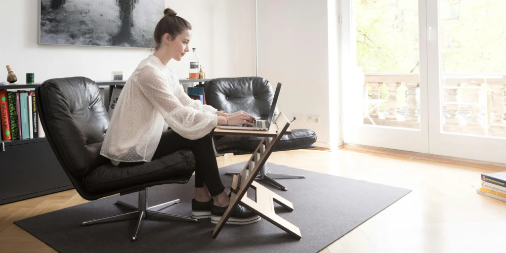 a girl insitting in front of laptop at home focusing on work which highlighlity flexibilty