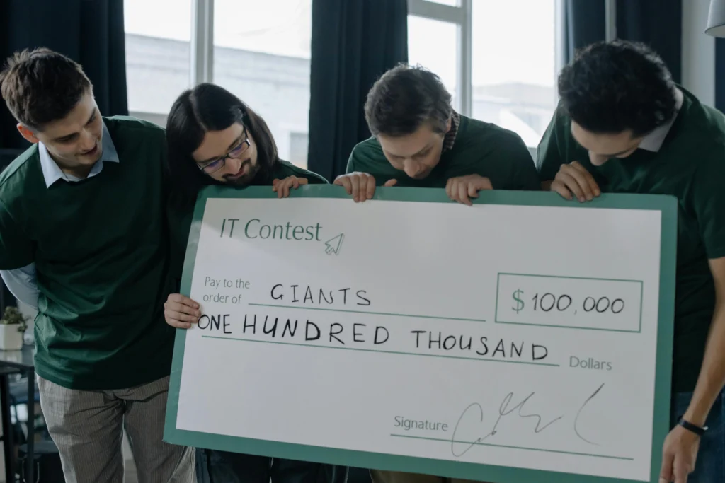 team holding chequeke recieved from investors